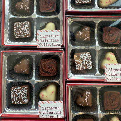 Collection of Valentine's Day chocolates in clear packaging with decorative designs.